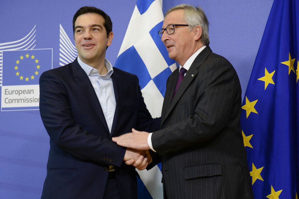 Handshake between Alexis Tsipras, on the left, and Jean-Claude Juncker