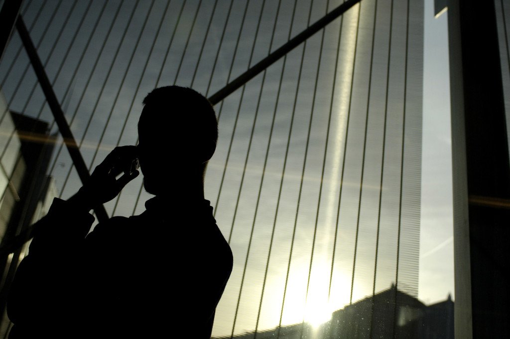 Person making a call on a mobile phone GSM at the EP in Brussels.
