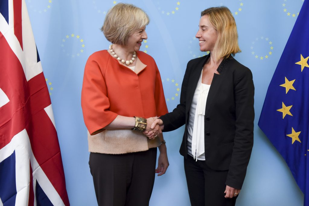 Handshake between Theresa May, on the left, and Federica Mogherini