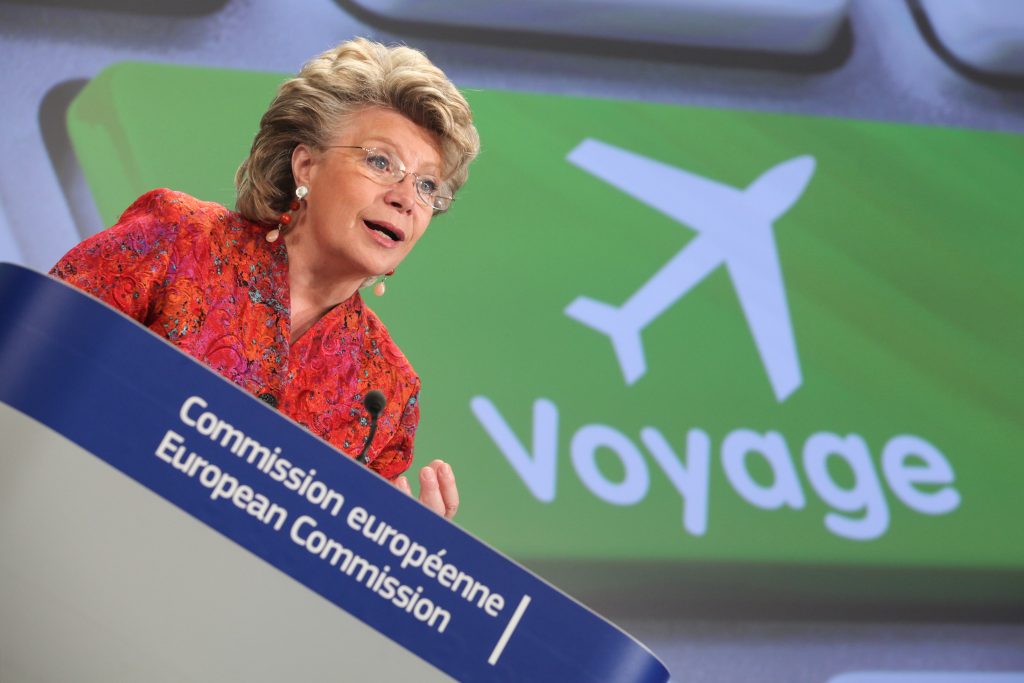 Viviane Reding, with in the background, the key of a computer keyboard representing the drawing of an airplane with the word "travel" (voyage)